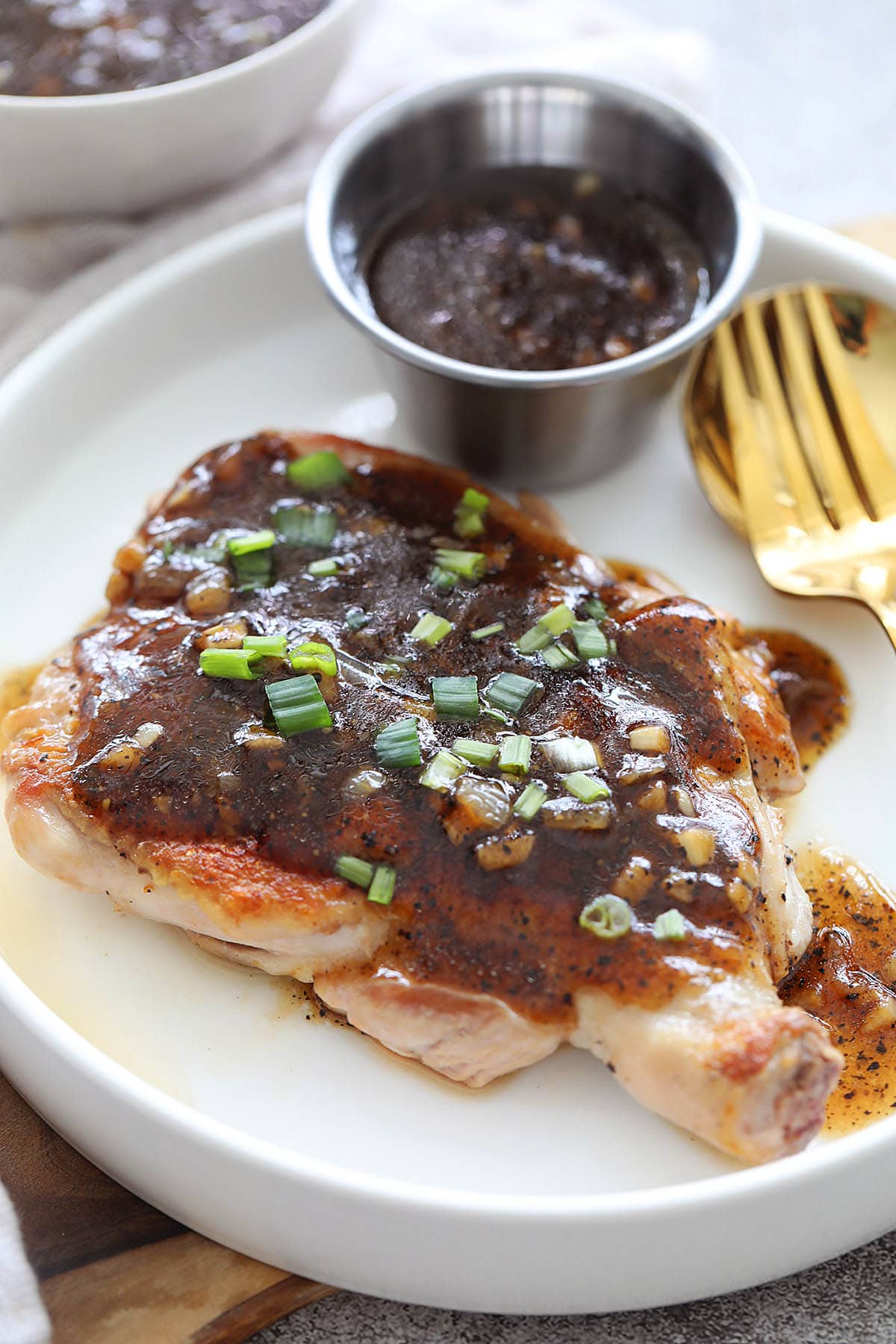 Black pepper chicken with homemade black pepper sauce, garnished with scallions.