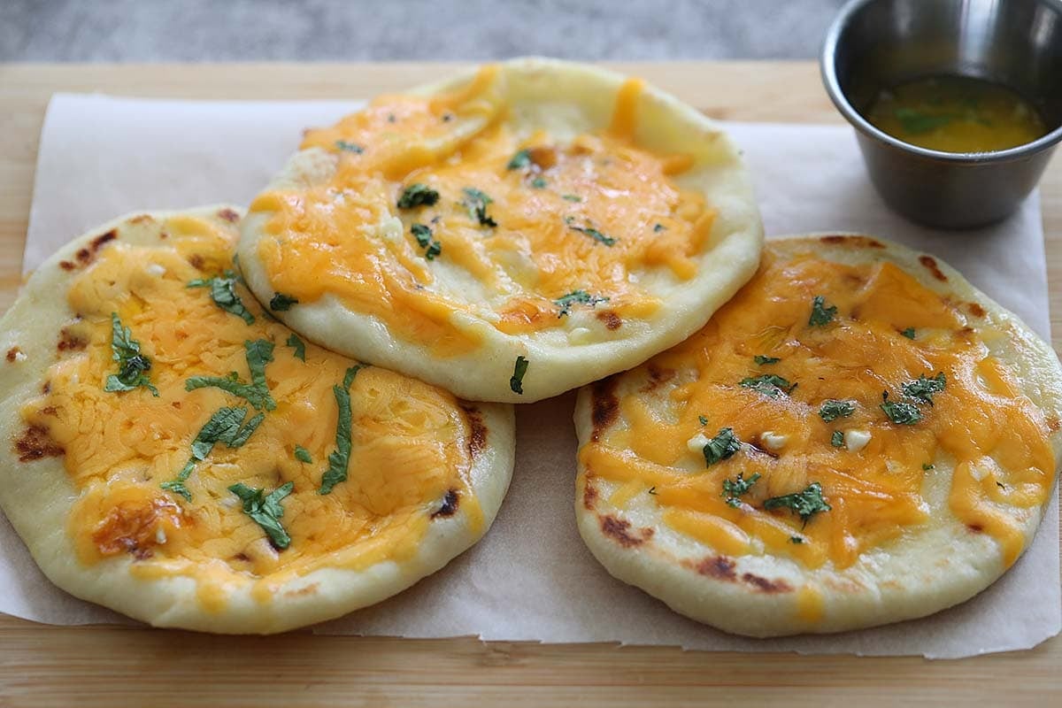 Garlic cheese naan garnished with cilantro.