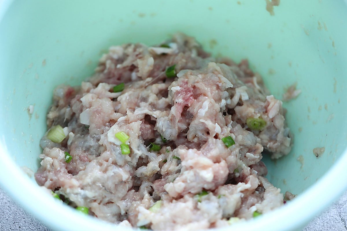 Filling for chicken wontons in a bowl.