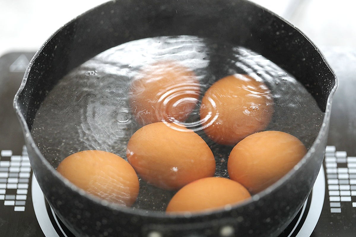 Eggs in a pot of hot water.