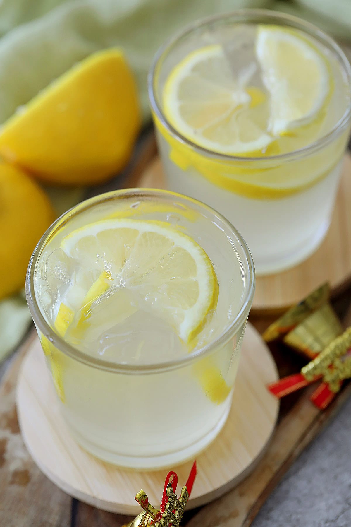 Lemon drop on the rocks made with fresh lemon juice and lemon wedges.
