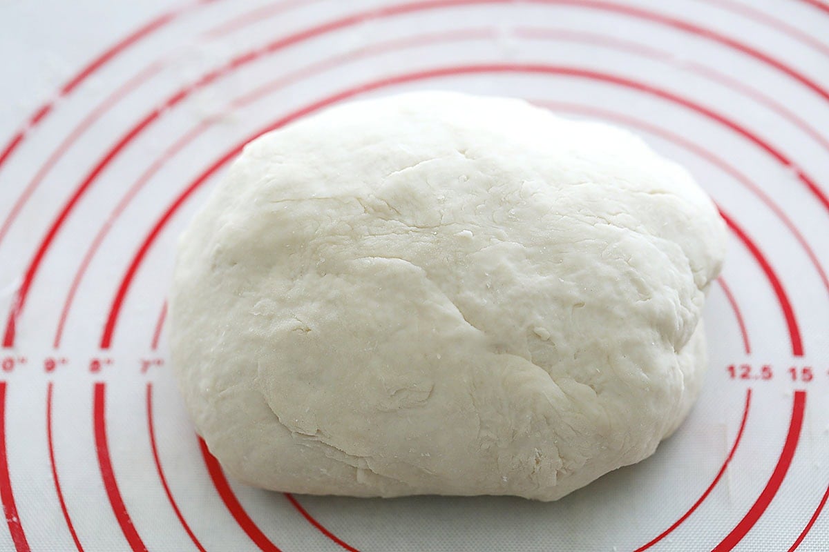 Naan dough on a silicon mat.
