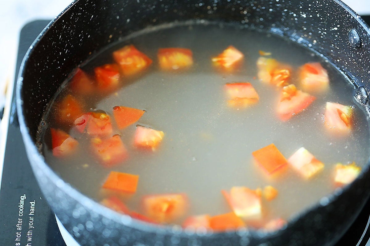 Tomato and soup base in a pot.