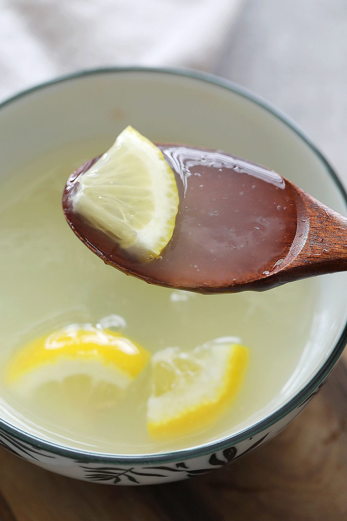 A spoonful of lemon sauce, ready to drizzle over chicken.