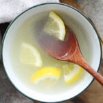 Lemon sauce with lemon slices served in a bowl.