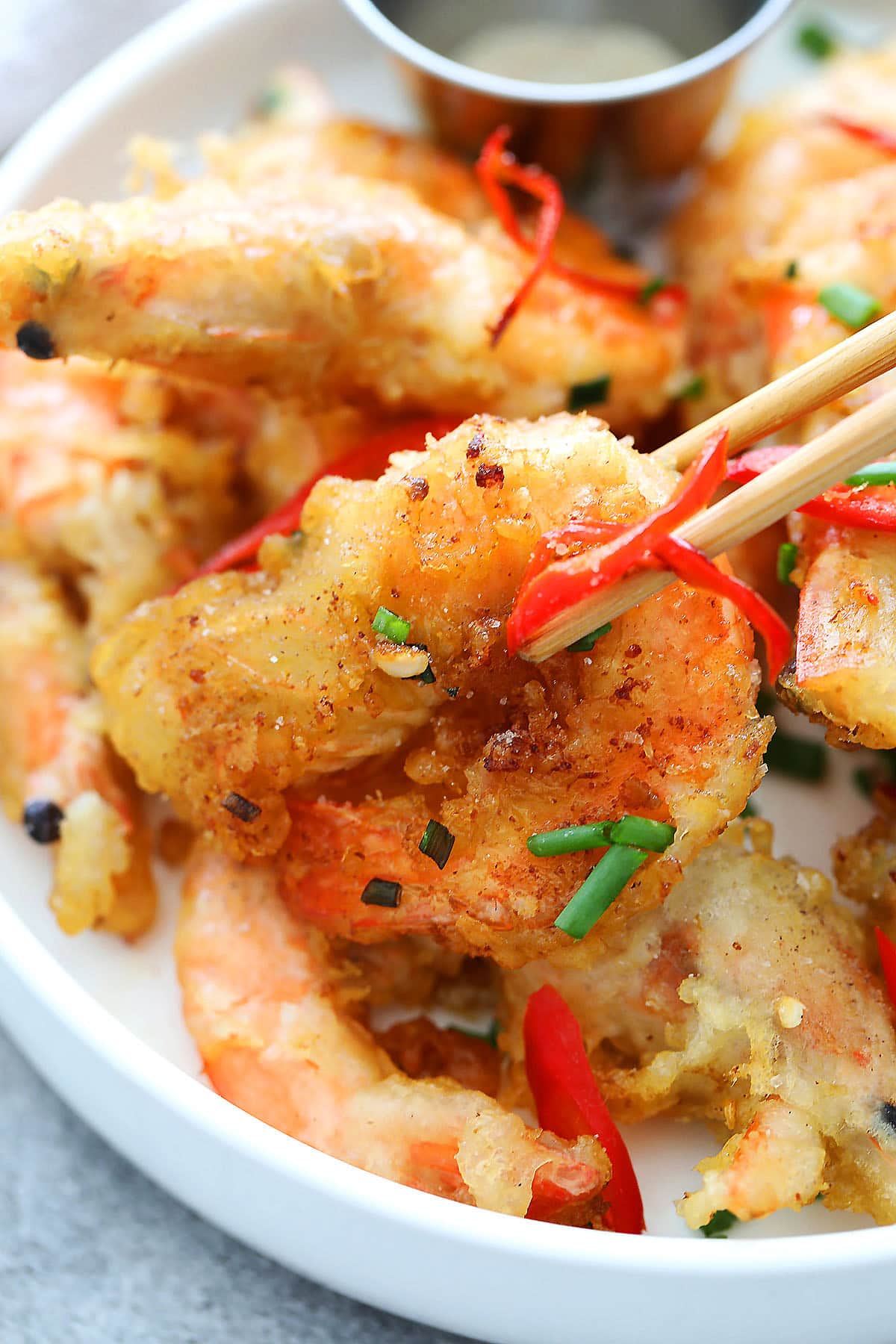 Crispy salt and pepper shrimp topped with red chilies and scallions.