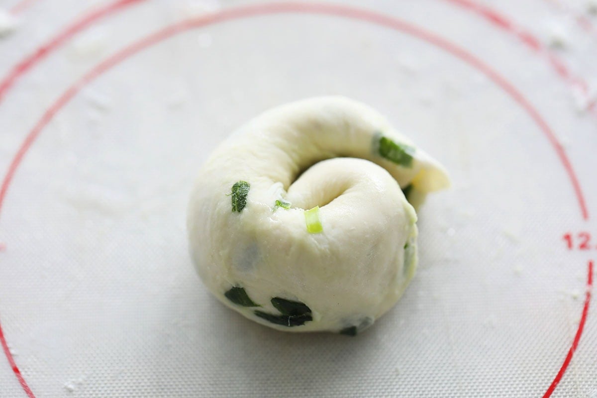 Coiled dough on a silicon mat.