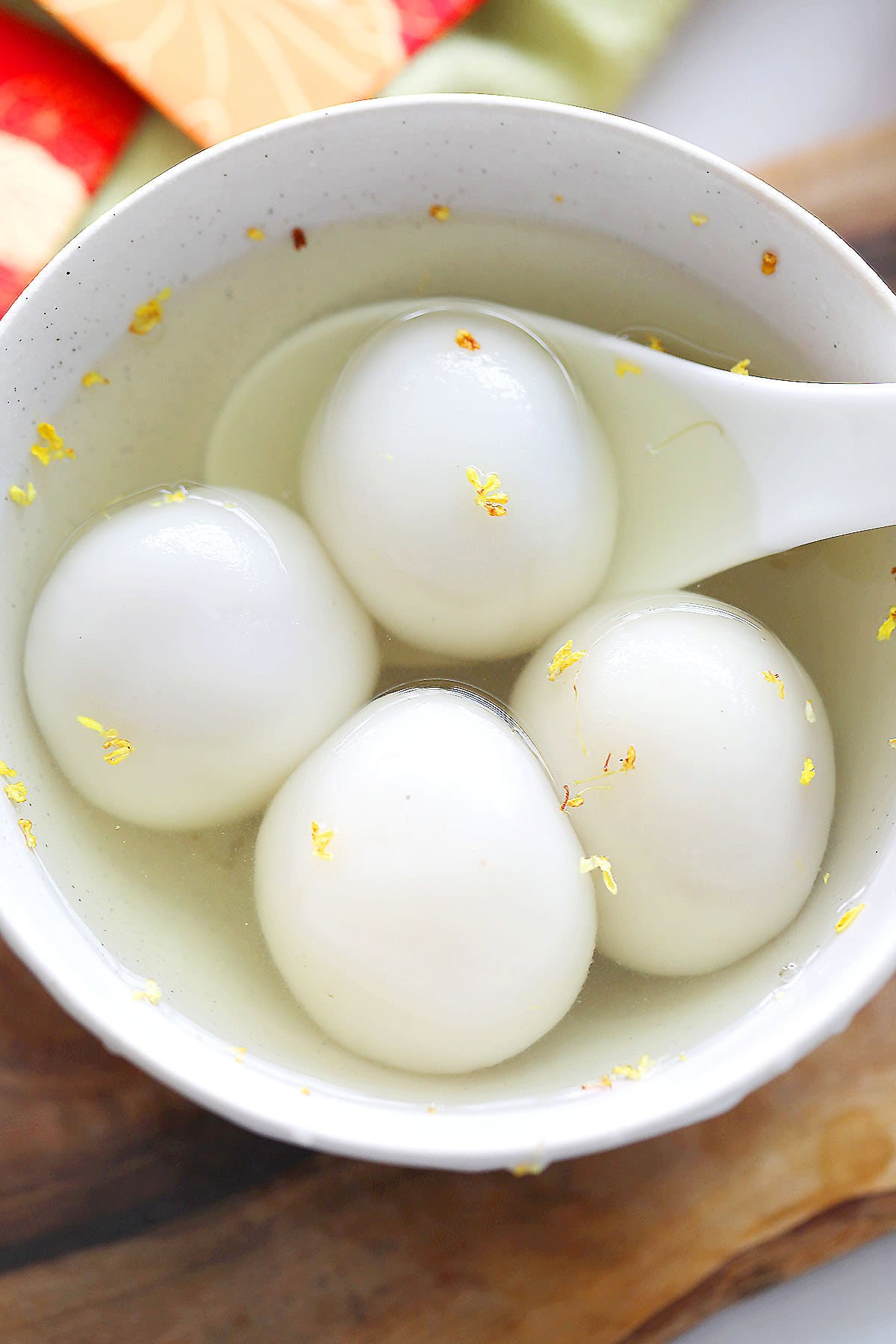Tang yuan with peanut filling in a bowl of sweet ginger soup.