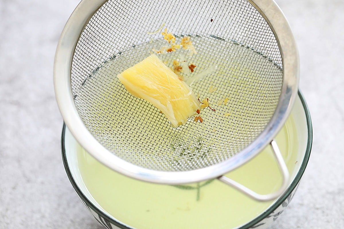 Ginger and sweet osmanthus on a fine mesh strainer.