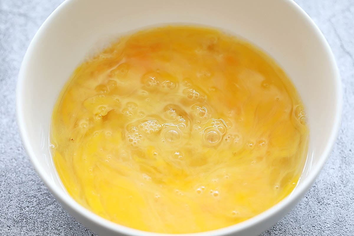 Beaten eggs in a bowl.