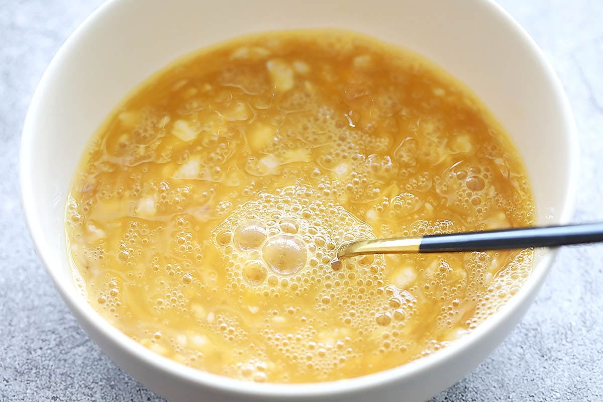Eggs and ground pork in a bowl.