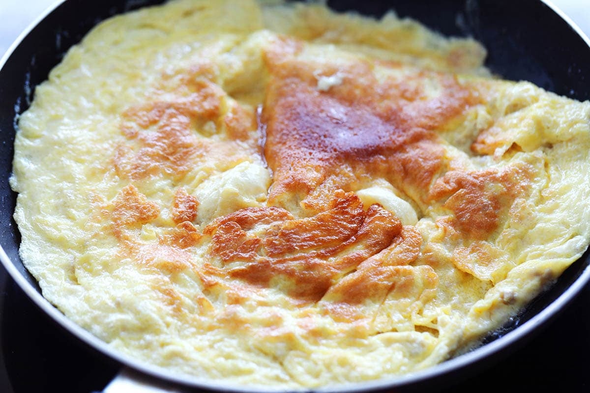 Crispy, golden brown eggs in a pan.