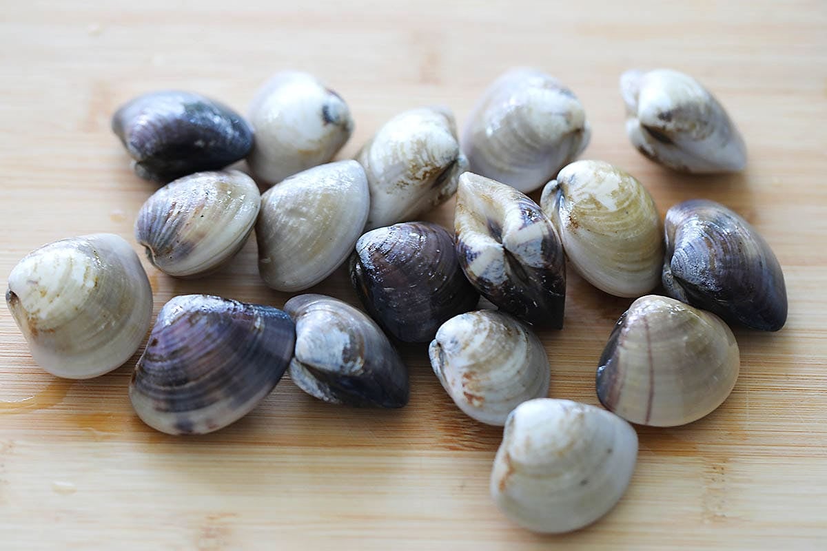 Manila clams on a board.
