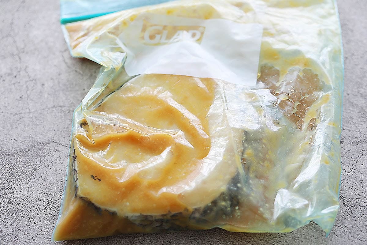 Black cod fillet and miso marinade in a ziplock bag.