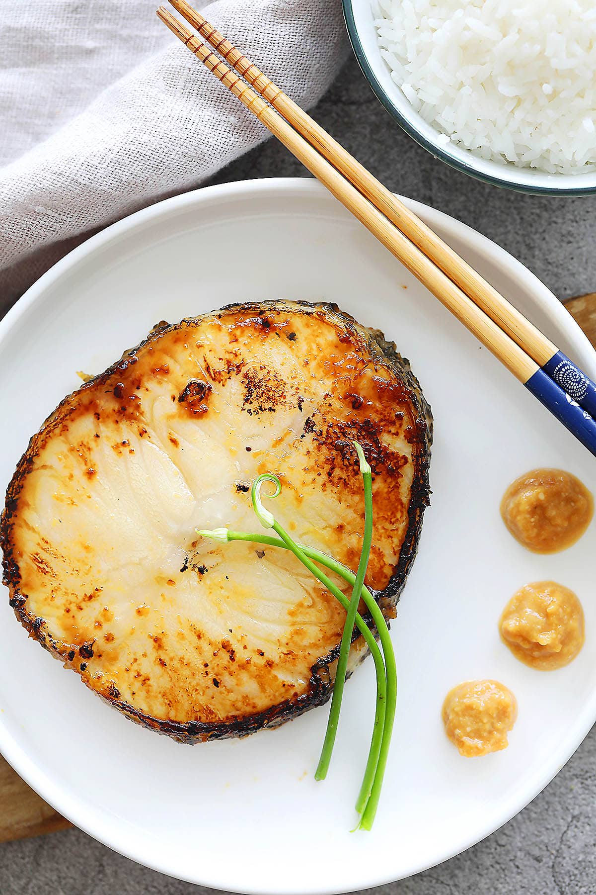 Miso cod served with a bowl of rice.