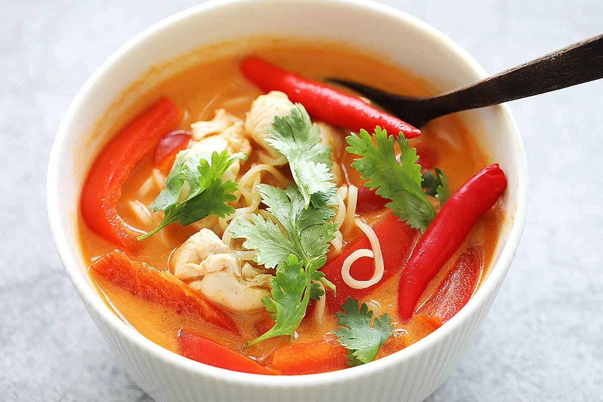 Authentic Thai coconut chicken noodle soup garnished with cilantro.