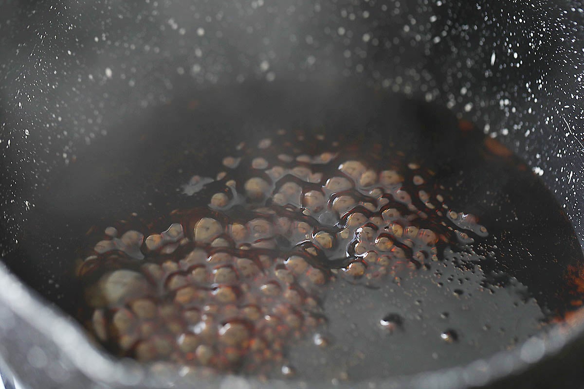 Homemade kung pao sauce simmering in a sauce pan.