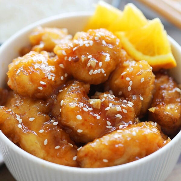 Crispy orange chicken with homemade orange sauce served in a bowl.