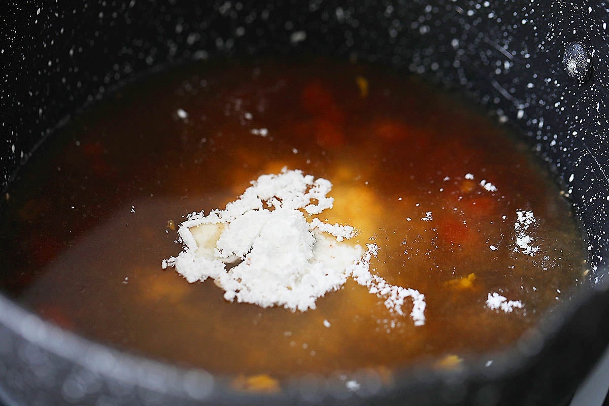 Orange sauce ingredients in a saucepan.