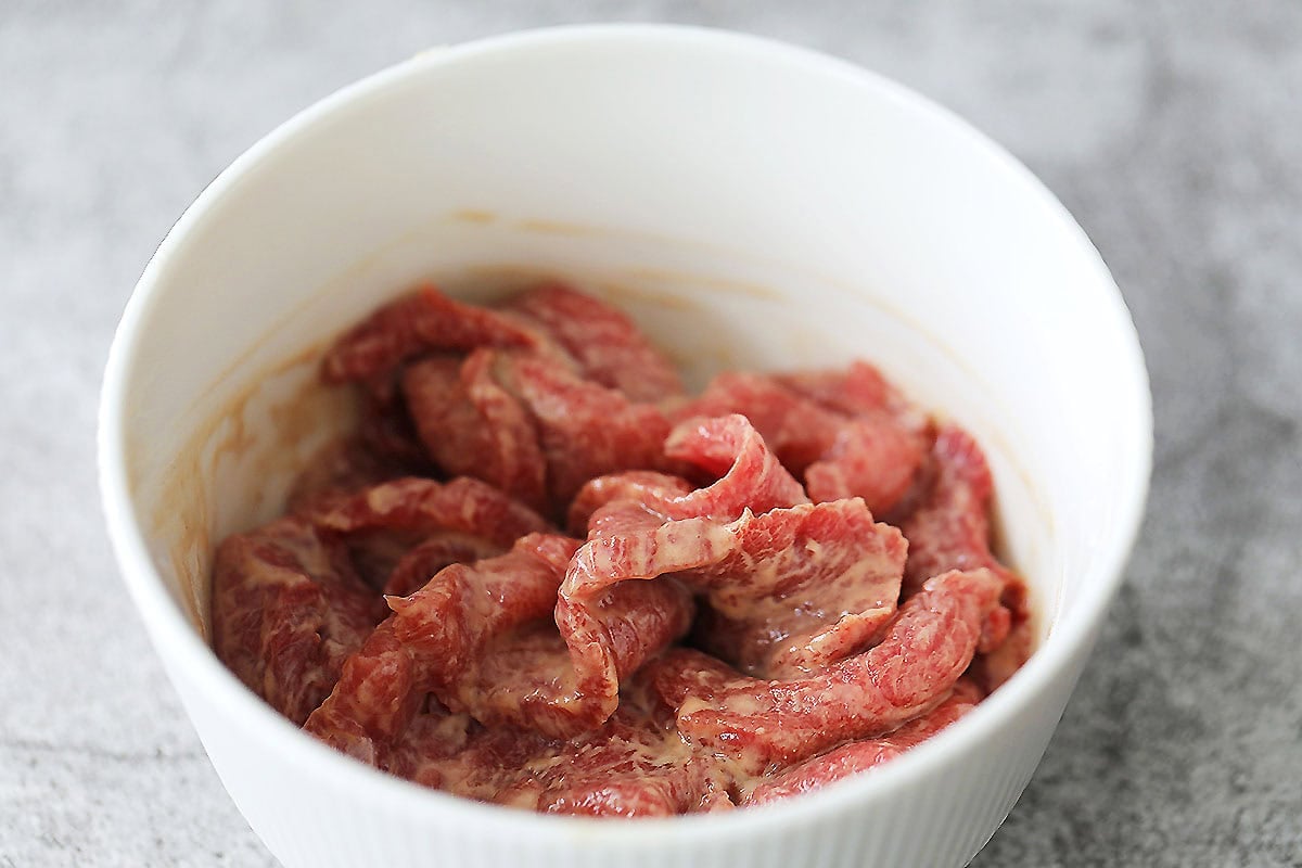 Marinated beef in a bowl.