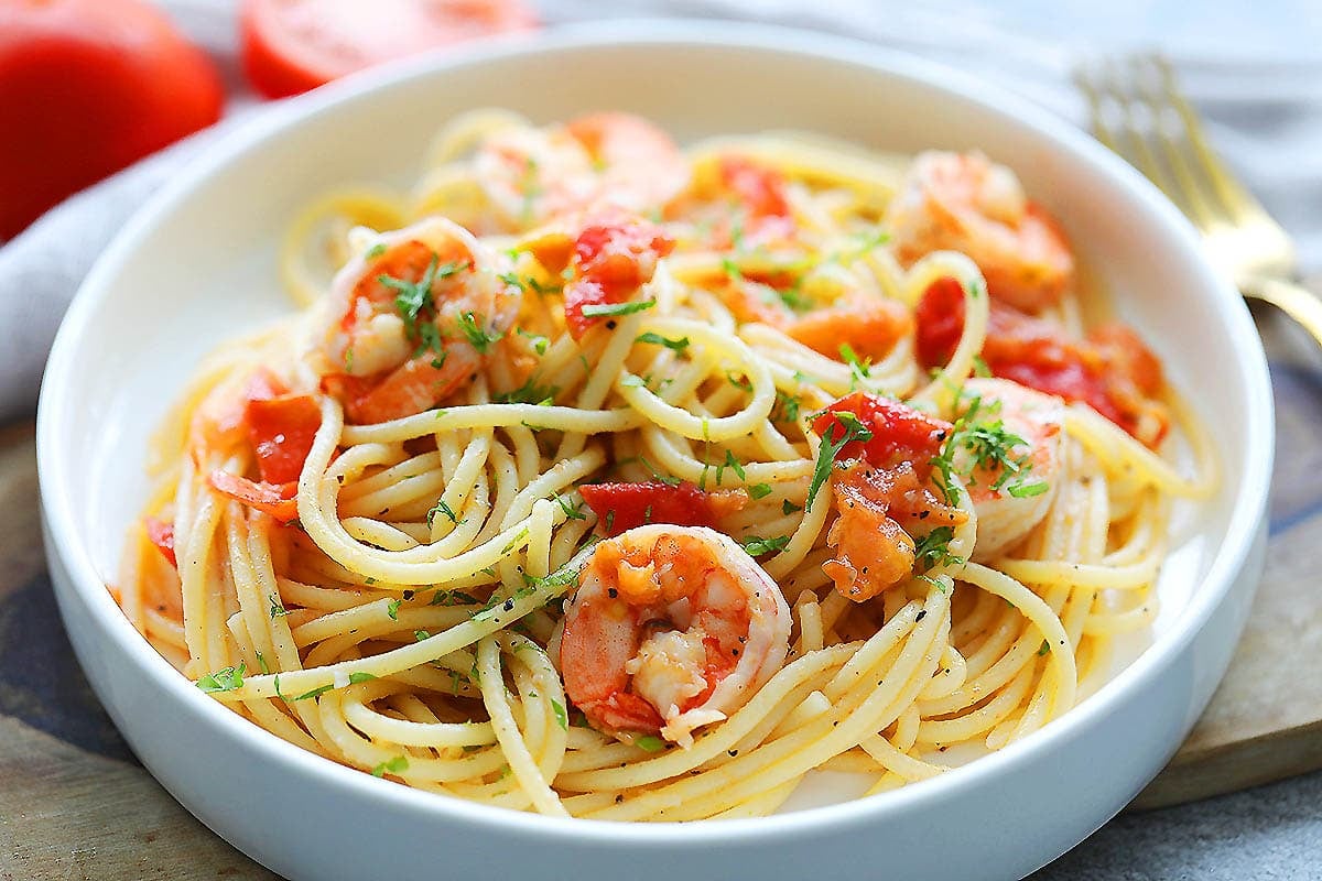 Authentic red sauce Italian shrimp pasta garnished with parsley.