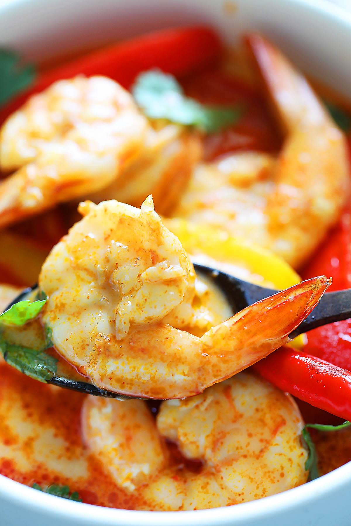 Spicy red curry shrimp served in a bowl.