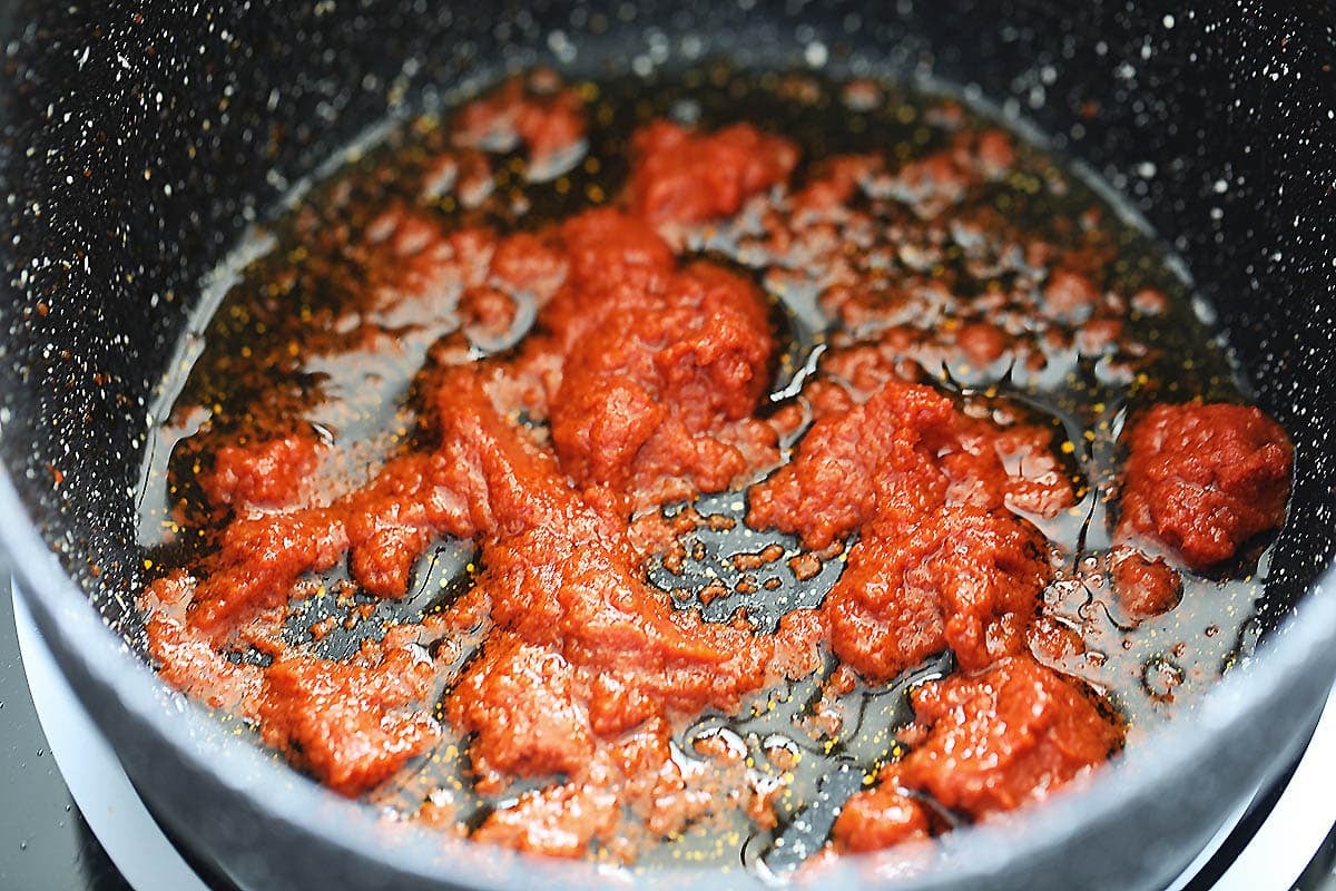 Red curry paste in a saucepan.