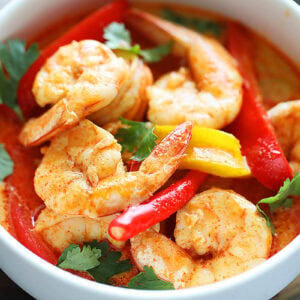 Authentic Thai red curry shrimp served in a bowl.