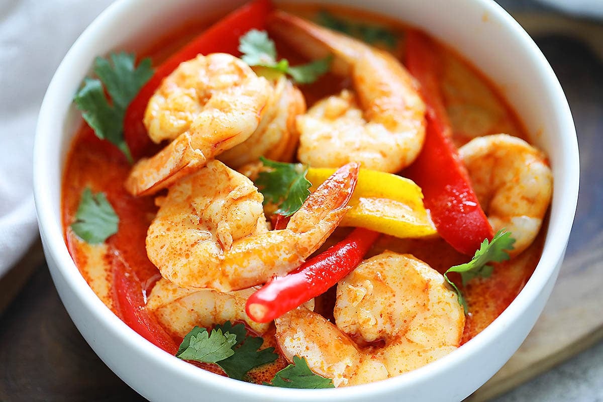 Authentic Thai red curry shrimp served in a bowl.