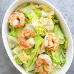 Sauteed cabbage with garlic and shrimp served in a deep dish.