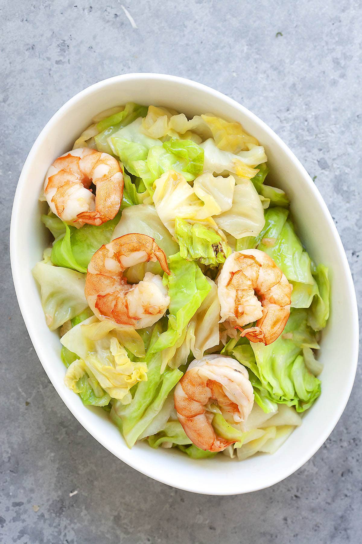 Sauteed cabbage with garlic and shrimp served in a deep dish.