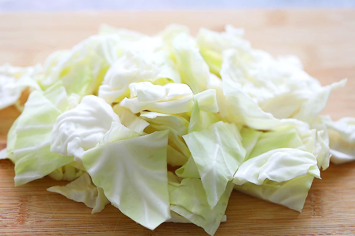 Chopped cabbage on a cutting board.