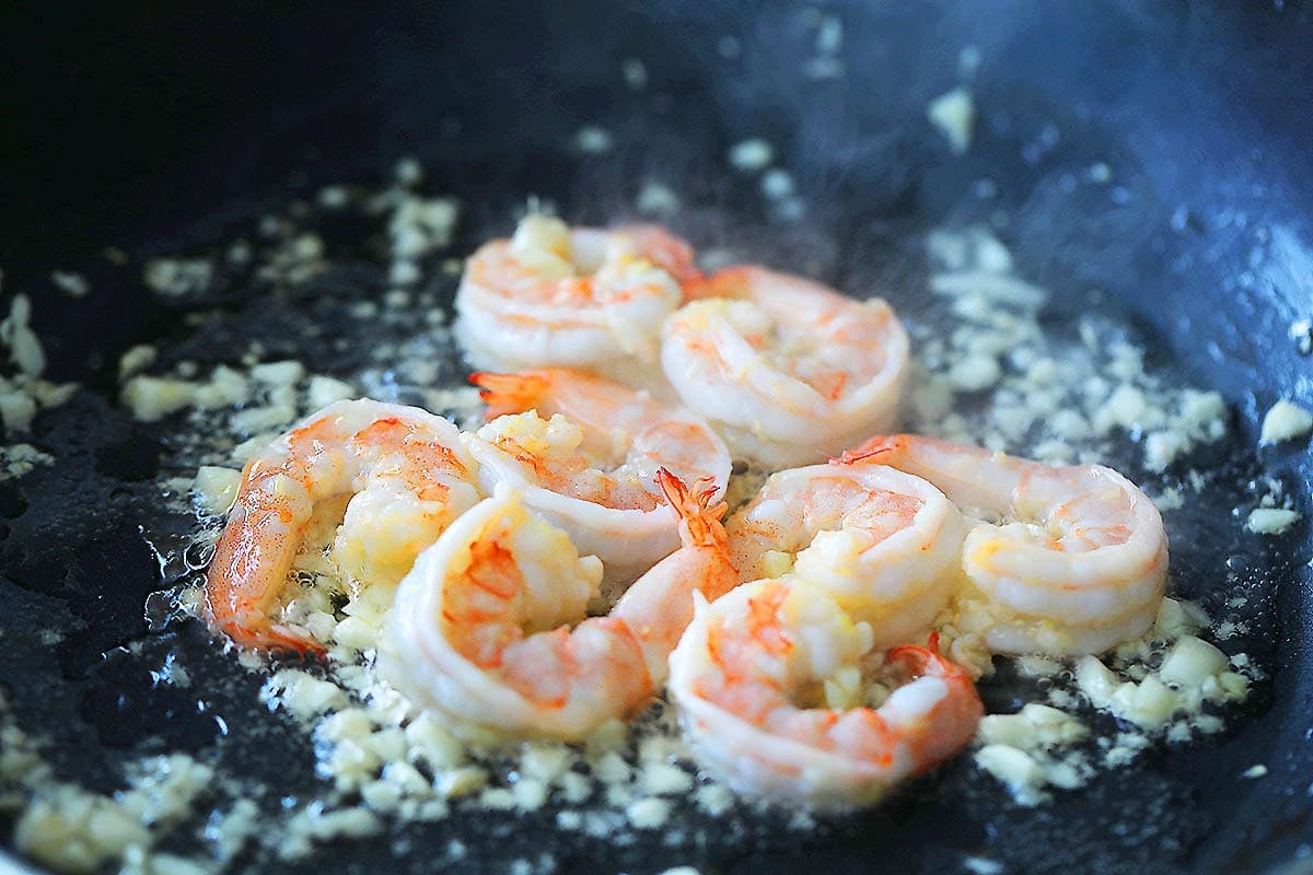 Shrimp and garlic in a pan.