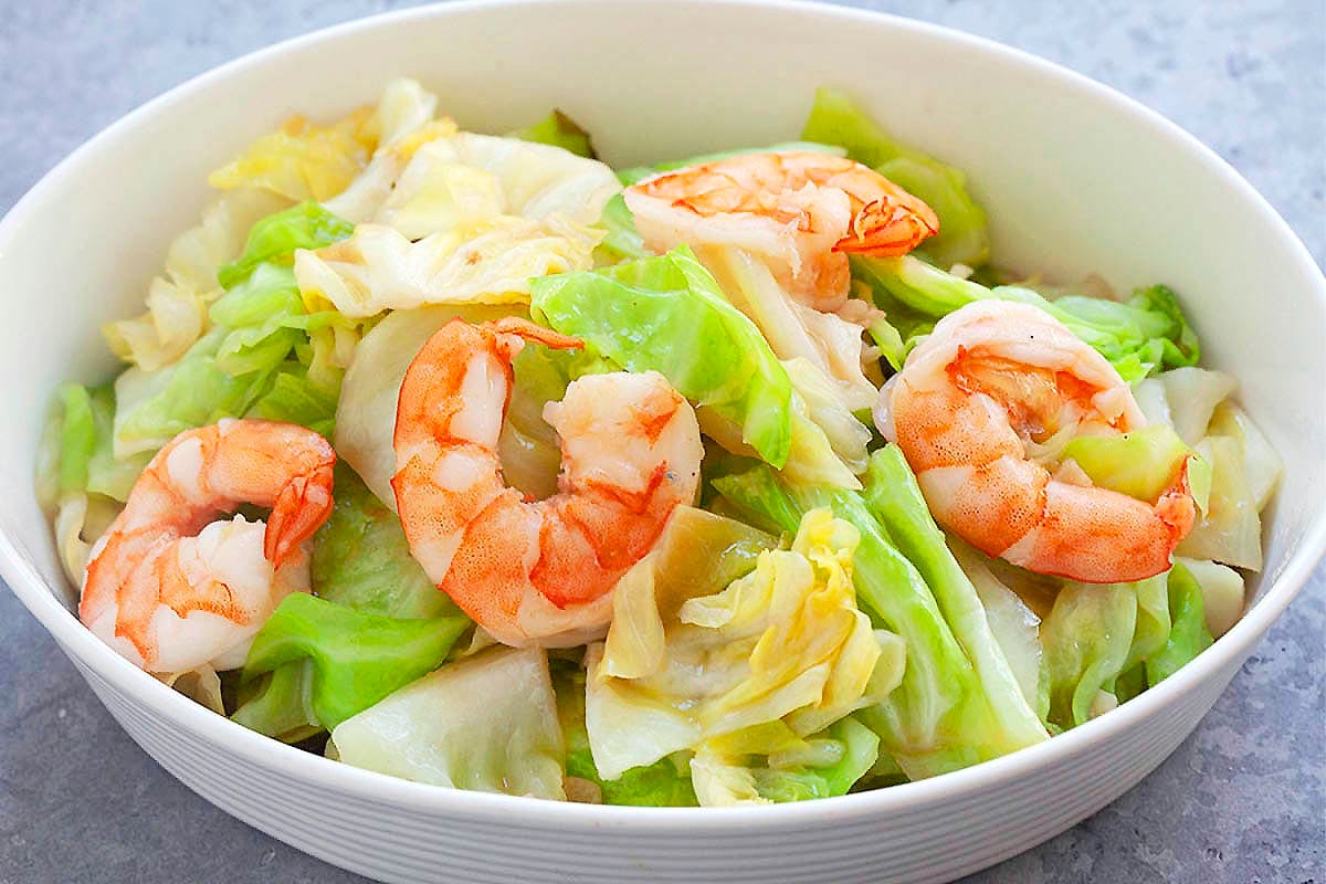 Chinese stir fry cabbage with garlic and shrimp, served in a deep dish.