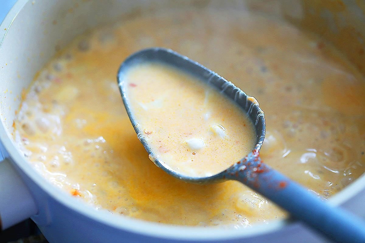 A spoonful of bisque and crab meat.