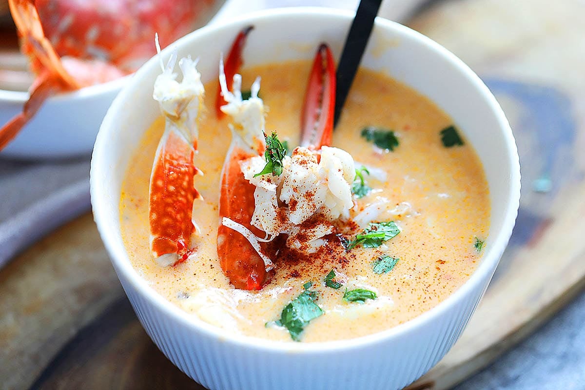 Thick and creamy crab bisque garnished with parsley.