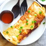 Crab omelette just like Jay Fai, garnished with scallions.