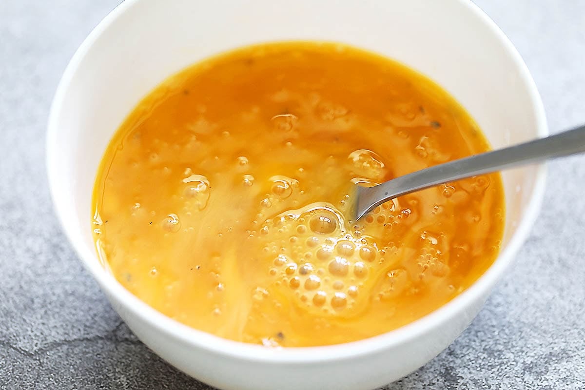 Beaten eggs in a bowl.