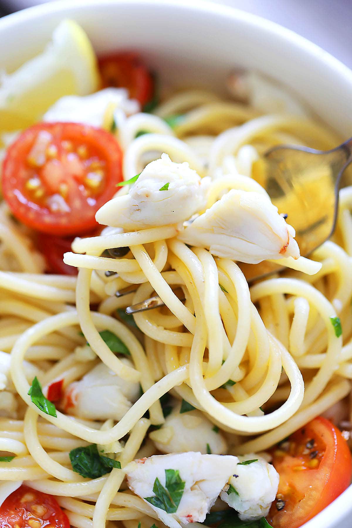 Crab lump meat pasta with cherry tomatoes and parsley.