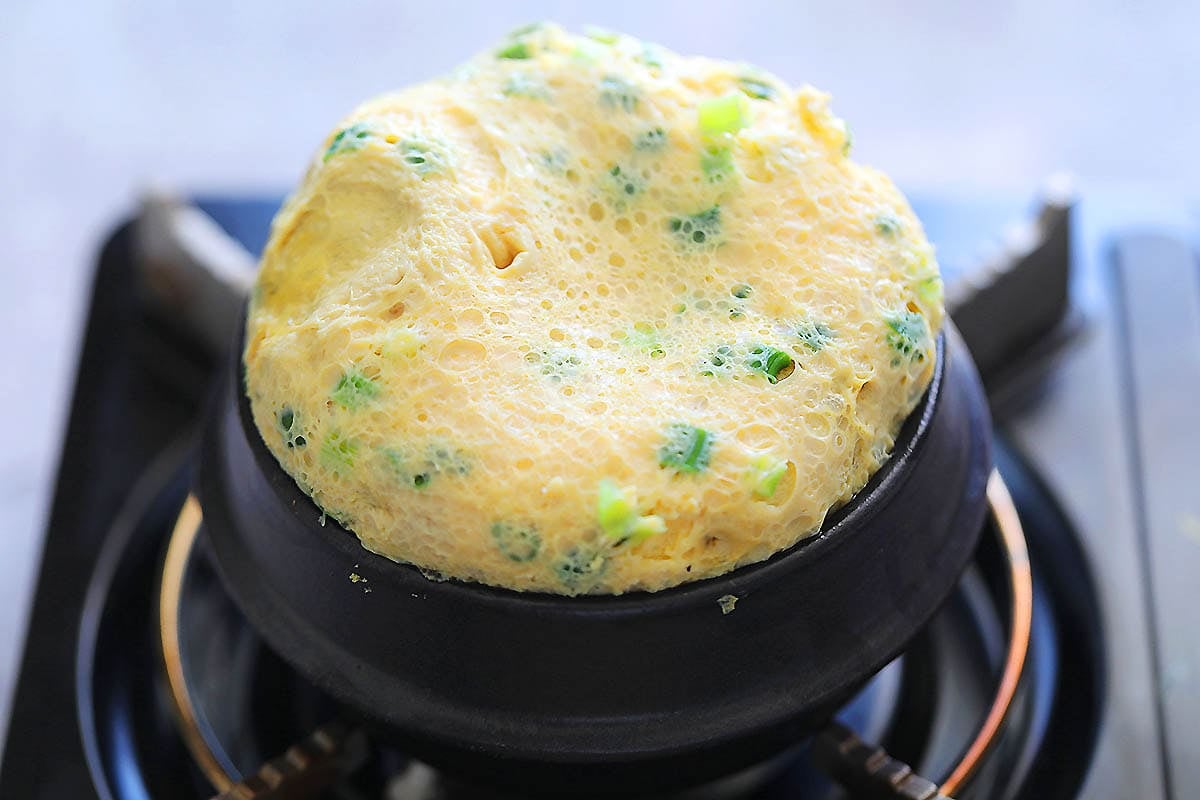 Fluffy Korean steamed egg on a stovetop.