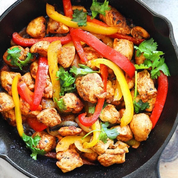 Easy sizzling chicken fajita recipe with homemade fajita seasoning, served in a cast iron skillet.