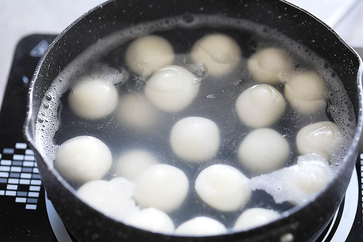 Rice dumplings in a pot of hot water.