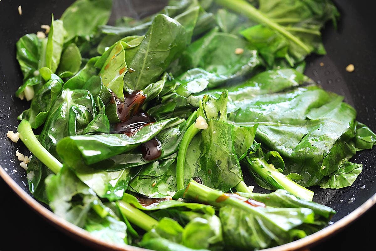 Chinese broccoli and oyster sauce in a pan.