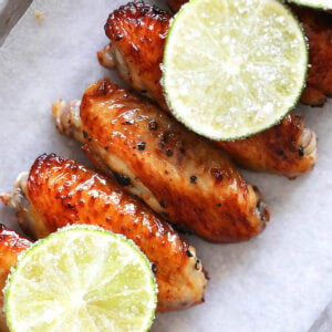 Honey lime chicken wings served with sugared lime slices.