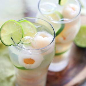 Iced lychee drink recipe with lime juice and lime slices.