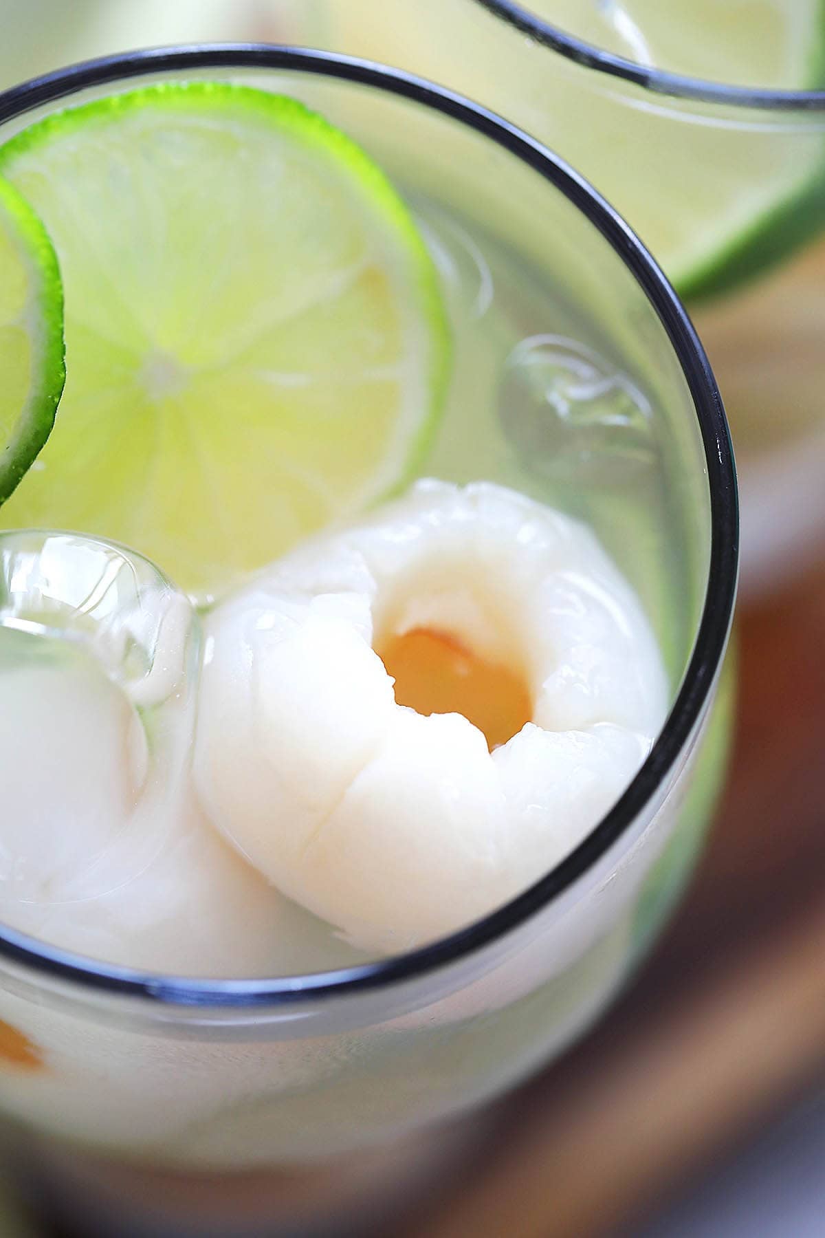 Iced lychee drink recipe with lime slices.