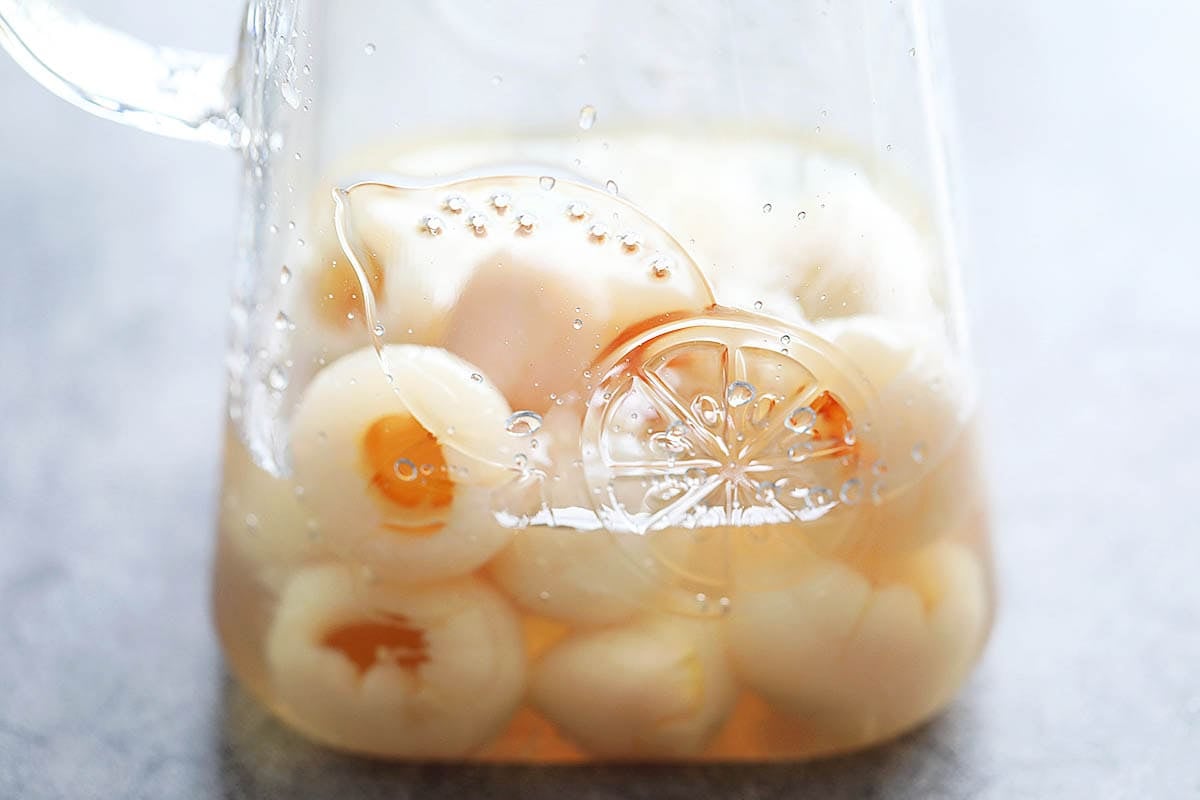 Canned lychee in syrup in a pitcher.