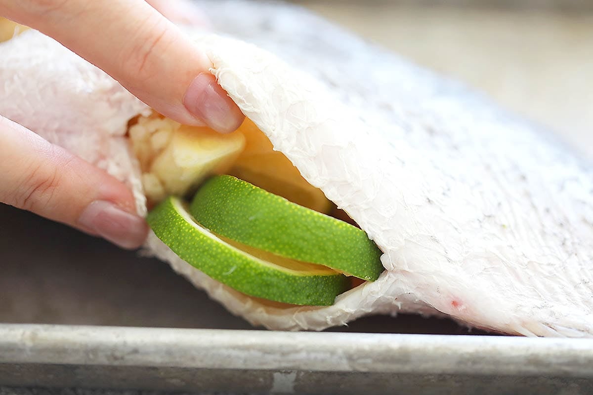 Belly of the fish stuffed with garlic and lime slices.