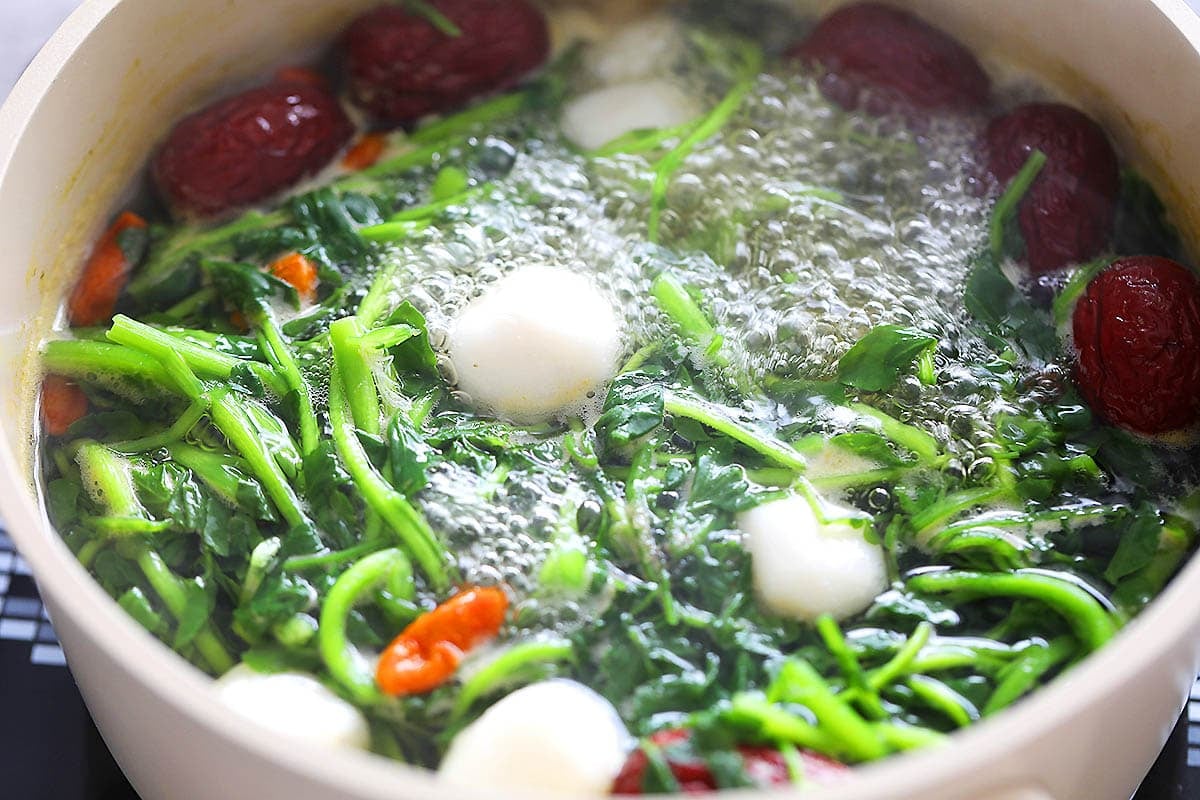 Chinese watercress soup boiling in a pot.