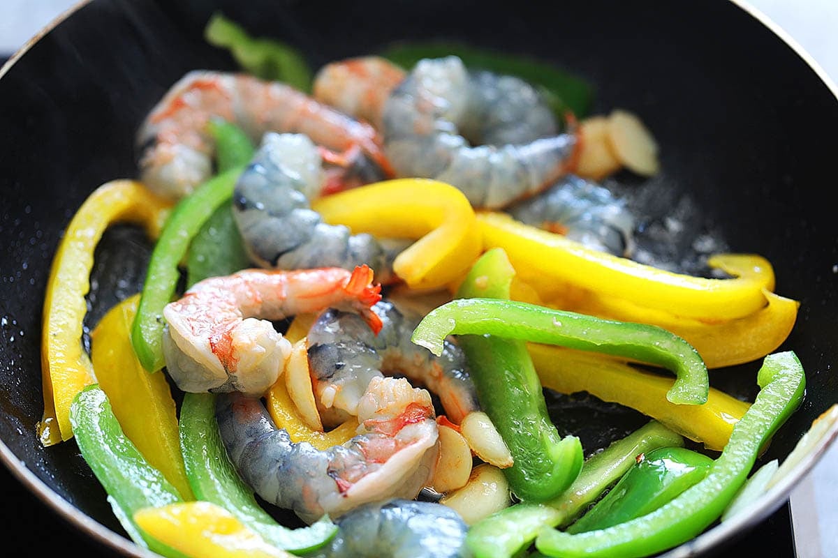 Shrimp and bell peppers in a skillet.
